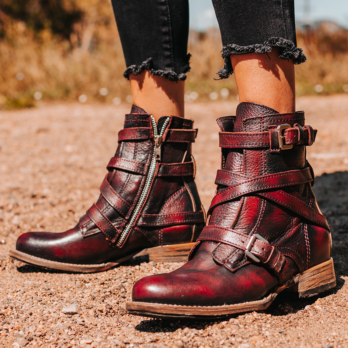 FREEBIRD women's Raine wine full grain leather bootie with inside zip closure, wooden heel, and leather overlays with metal buckles