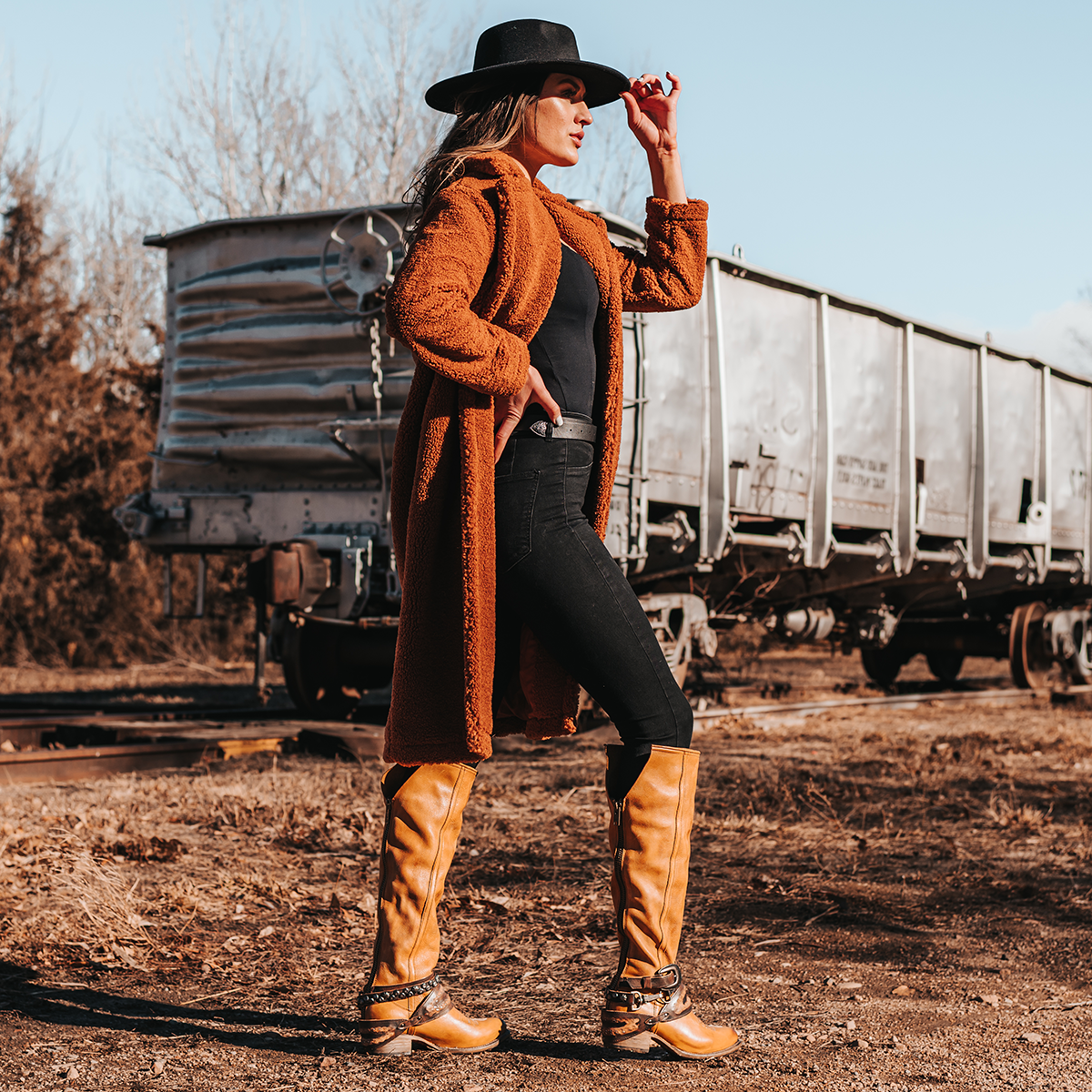 FREEBIRD women's Rodondo wheat boot featuring a a relaxed silhouette, low heel, and mixed metal buckles lifestyle image