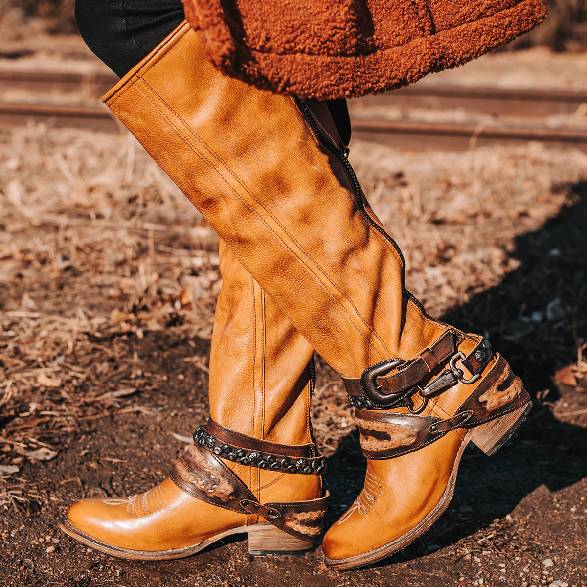FREEBIRD women's Rodondo wheat boot featuring a a relaxed silhouette, low heel, and mixed metal buckles