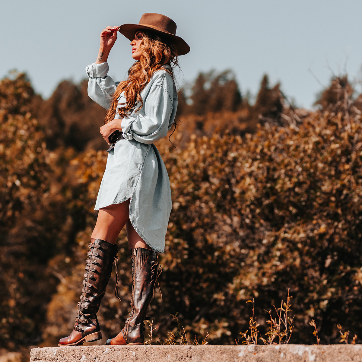 FREEBIRD women's Rylan cognac multi tall boot with inside zip closure back lacing and shaft with brass buckles lifestyle