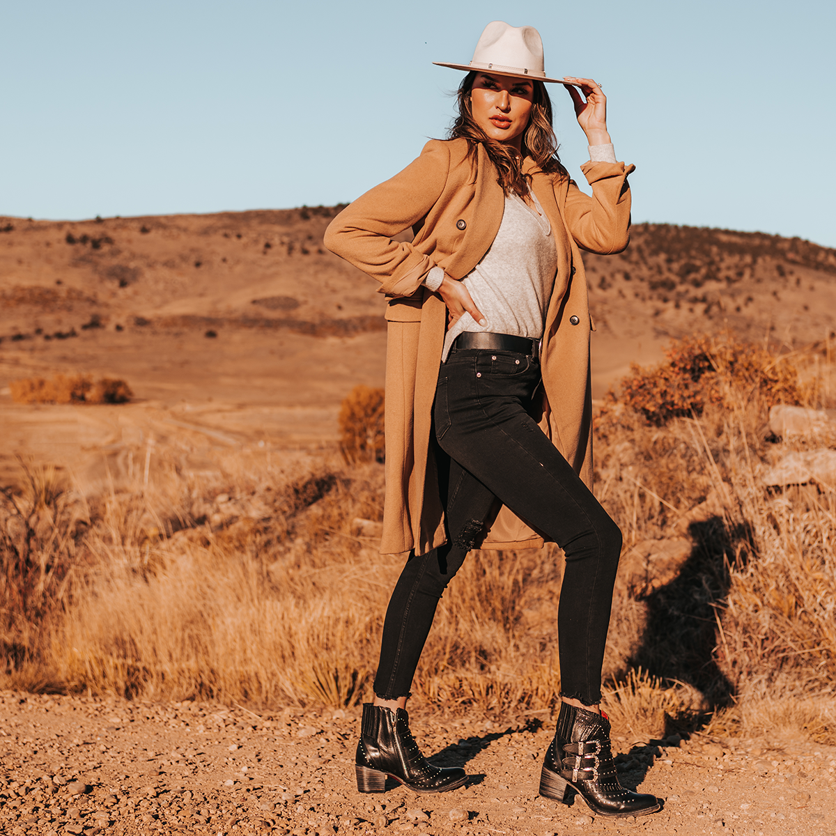 FREEBIRD women's Savanna black leather ankle bootie with silver studs, elastic gore, and metal buckles lifestyle