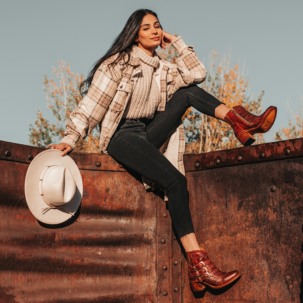 FREEBIRD women's Savanna cognac leather ankle bootie with silver studs, elastic gore, and metal buckles lifestyle