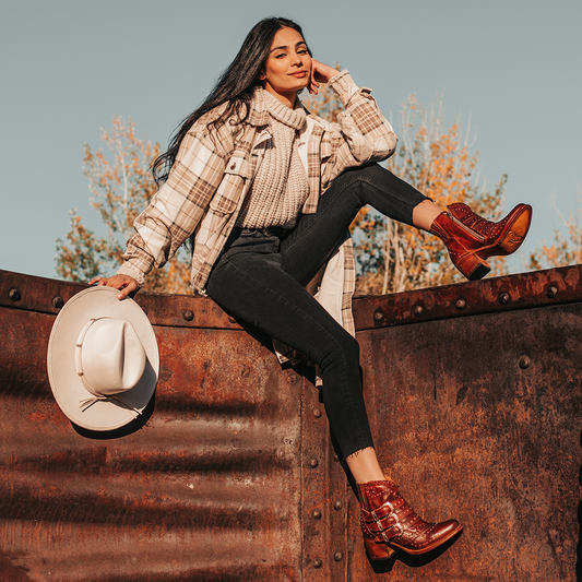 FREEBIRD women's Savanna cognac leather ankle bootie with silver studs, elastic gore, and metal buckles lifestyle