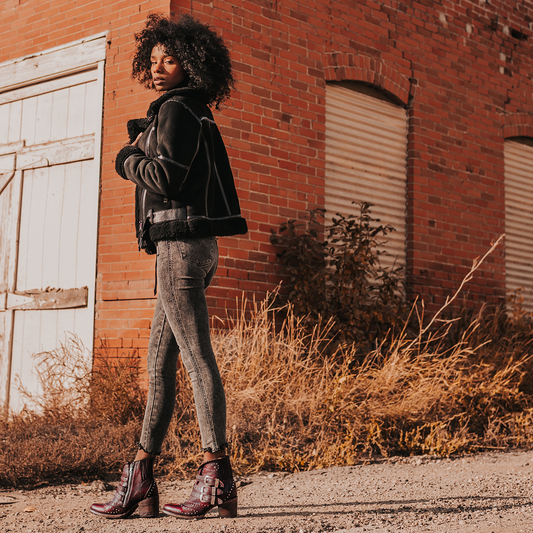 FREEBIRD women's Savanna wine leather ankle bootie with silver studs, elastic gore, and metal buckles lifestyle