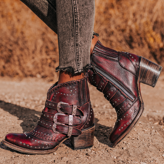 FREEBIRD women's Savanna wine leather ankle bootie with silver studs, elastic gore, and metal buckles
