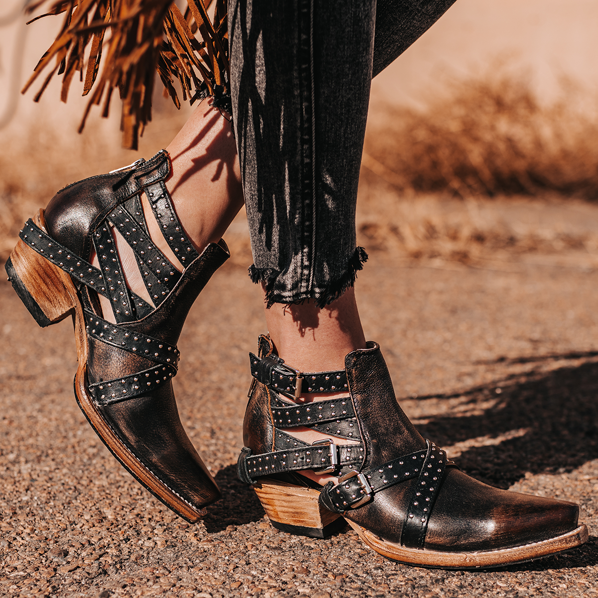 FREEBIRD women's Wasp black ankle bootie with exposed sides, adjustable fastener metal buckles, working back zip closure, snip toe, and traditional snip toe