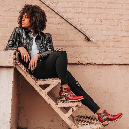 FREEBIRD women's Wasp red ankle bootie with exposed sides, adjustable fastener metal buckles, working back zip closure, snip toe, and traditional snip toe lifestyle