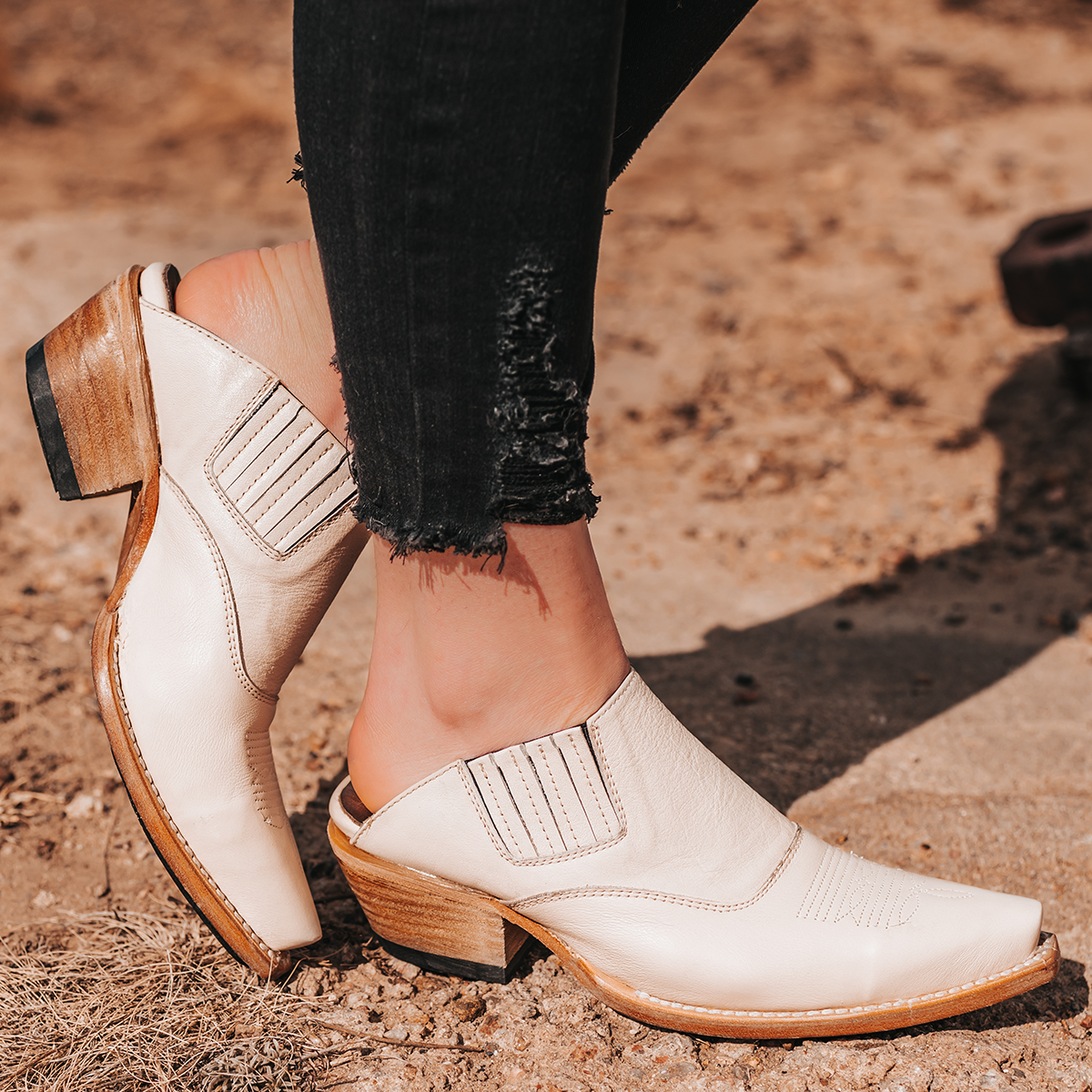 FREEBIRD women's Wentworth beige western mule featuring elastic gore, stitch detailing, open back, and snip toe