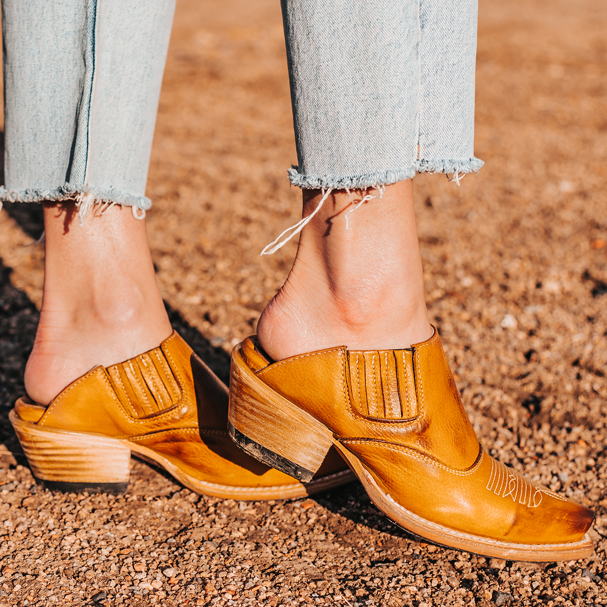 FREEBIRD women's Wentworth wheat western mule featuring elastic gore, stitch detailing, open back, and snip toe