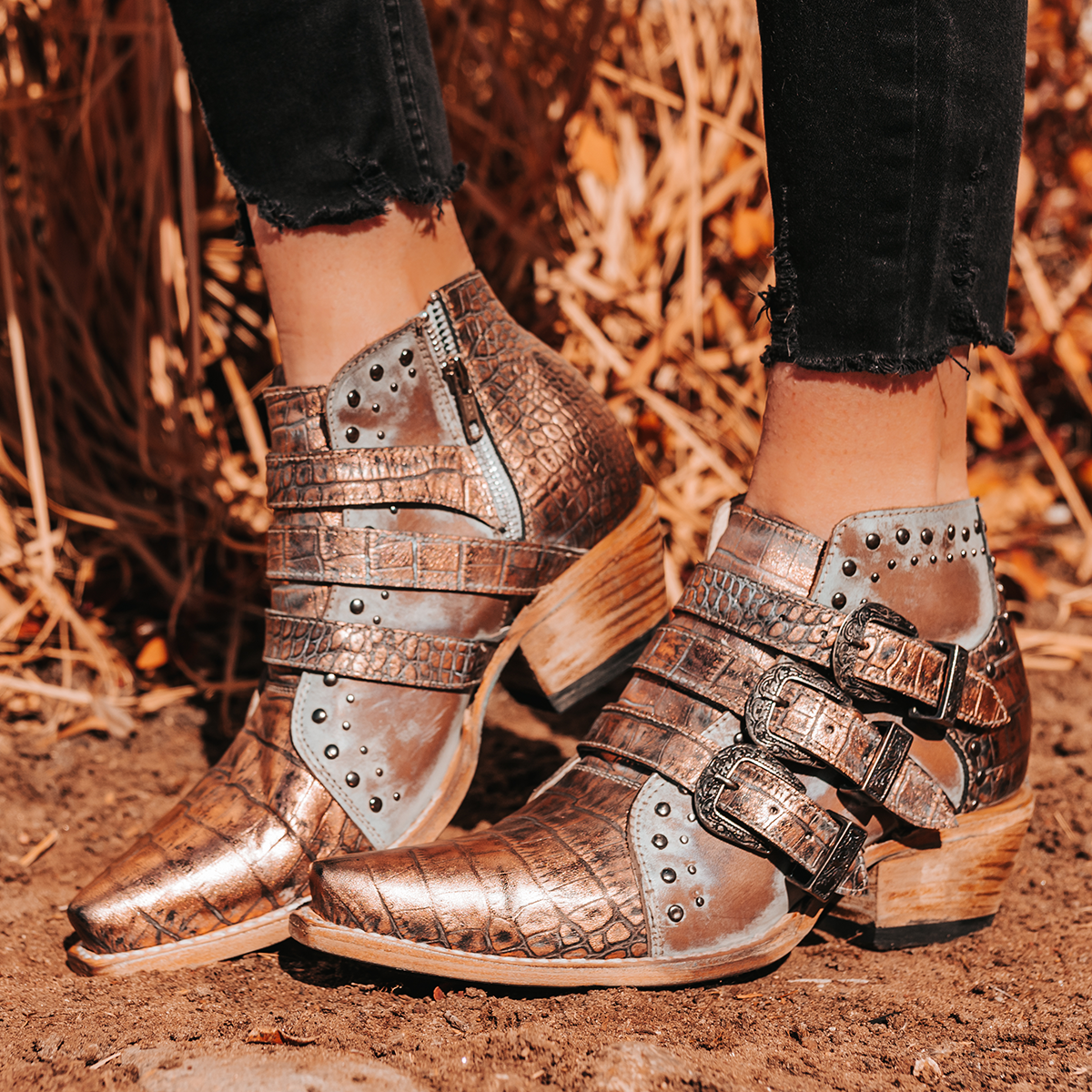 FREEBIRD women's WHILHELMINA blush croco ankle bootie featuring engraved metal buckles, snip toe, and embellished stud detailing