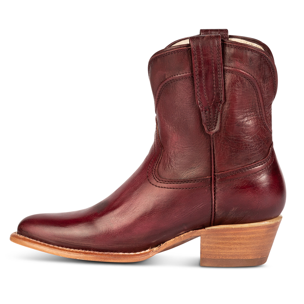 Side view showing leather pull straps and scallop detailing on FREEBIRD women's Zamora wine leather bootie