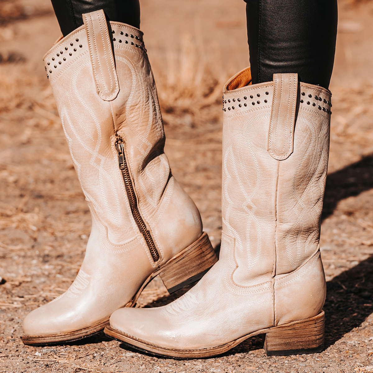 FREEBIRD women's Zion beige slim fit mid calf boot with stud detailing, almond-shaped toe, low heel, and pull on straps