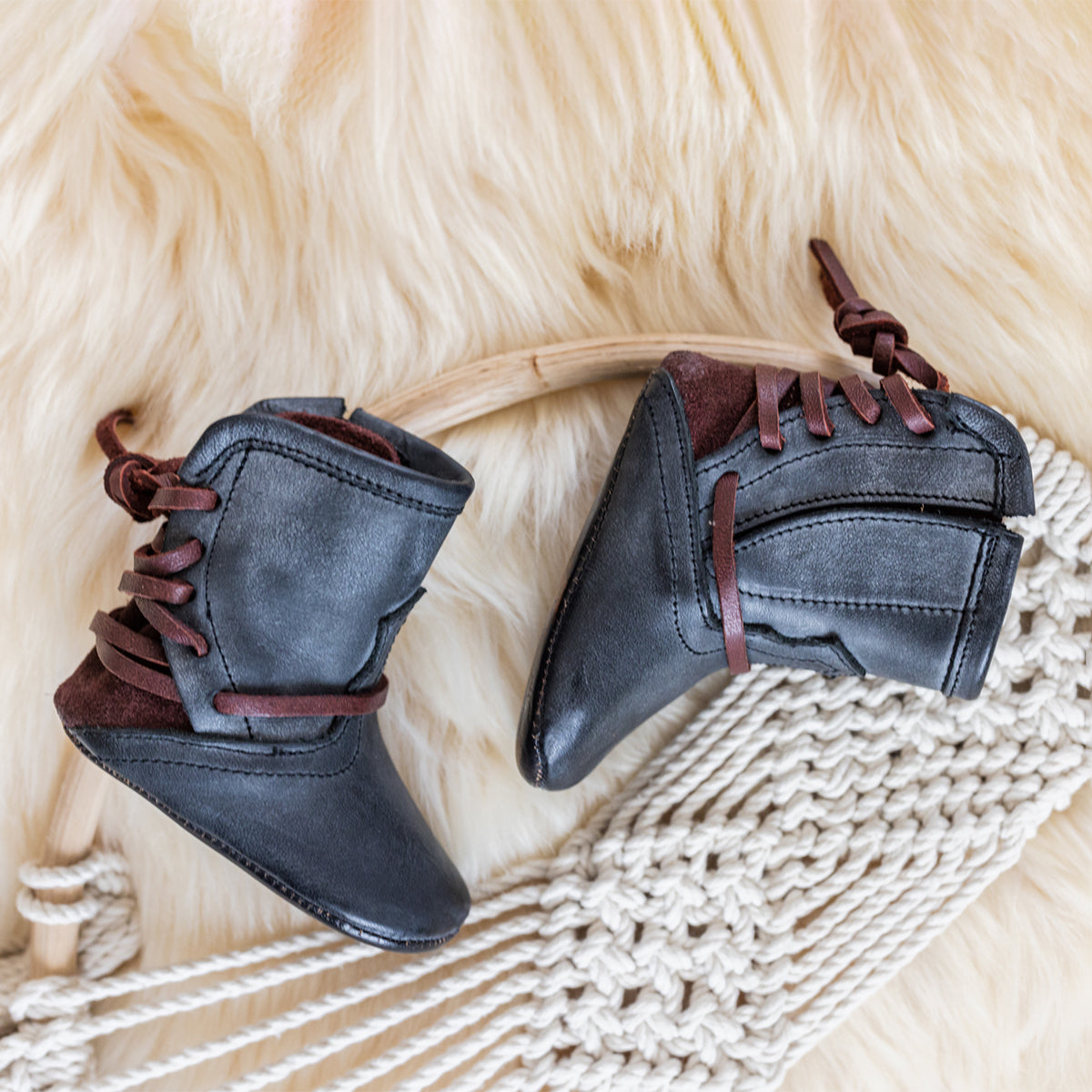 FREEBIRD infant baby coal black back lace detailing leather bootie with inside velcro closure lifestyle image