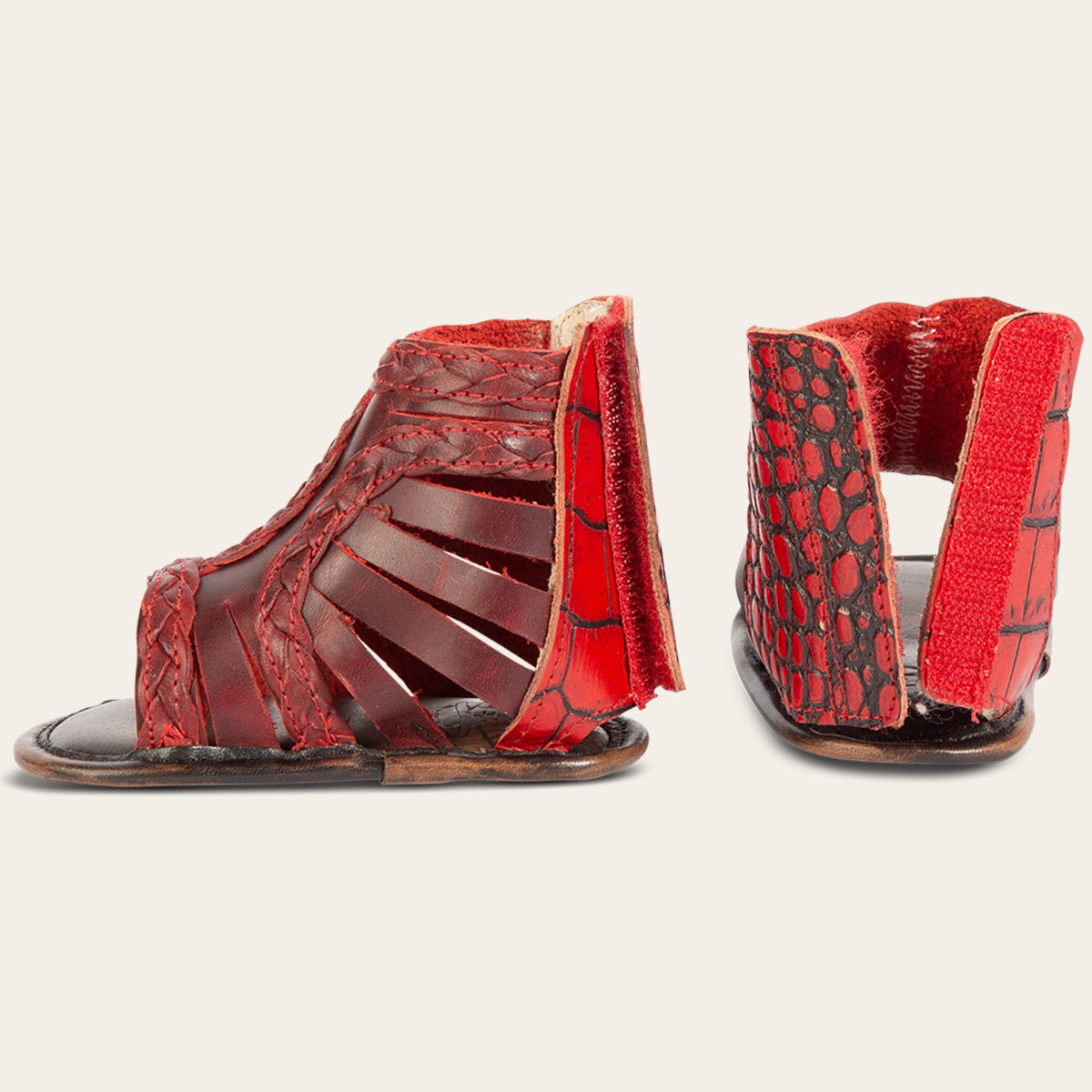 side and back view showing laser-cut leather, braided accents and embossed leather back velcro panel on FREEBIRD infant baby bela red leather sandal