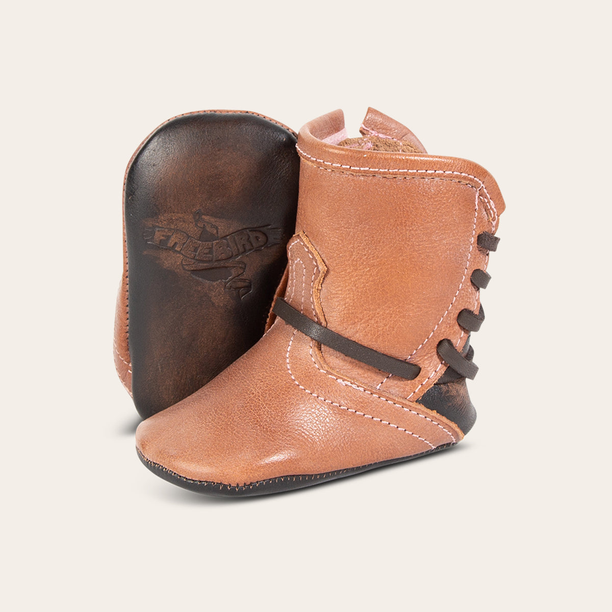 front view showing contrasting leather lace detailing and soft leather imprinted sole on FREEBIRD infant baby coal dusty rose leather bootie 