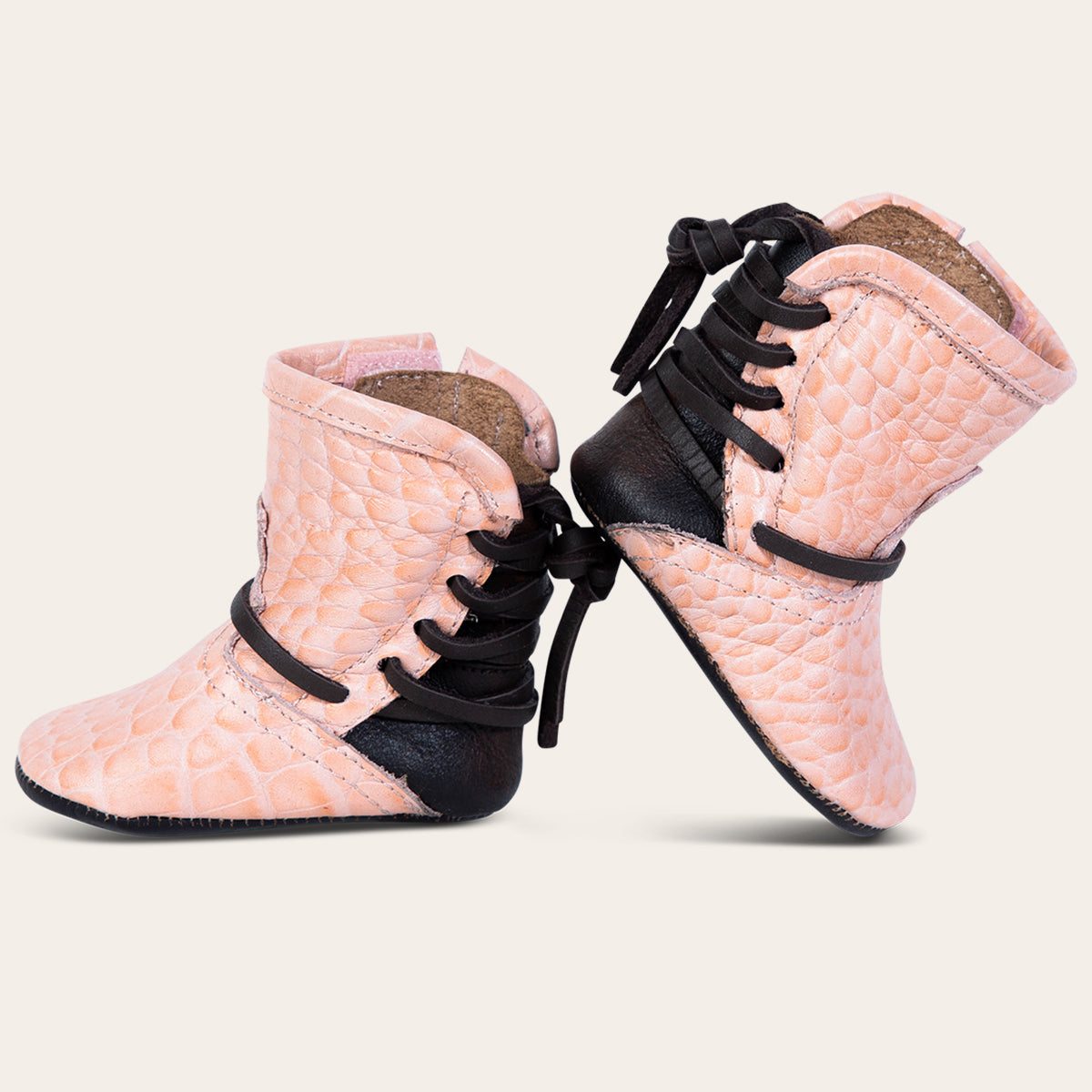 side view showing contrasting back lace detailing on FREEBIRD infant baby coal pink croco leather bootie 