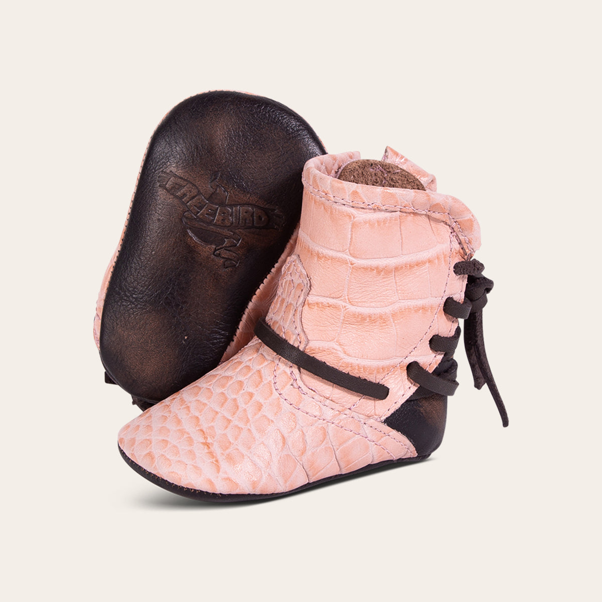 front view showing contrasting leather lace detailing and soft leather imprinted sole on FREEBIRD infant baby coal pink croco leather bootie 