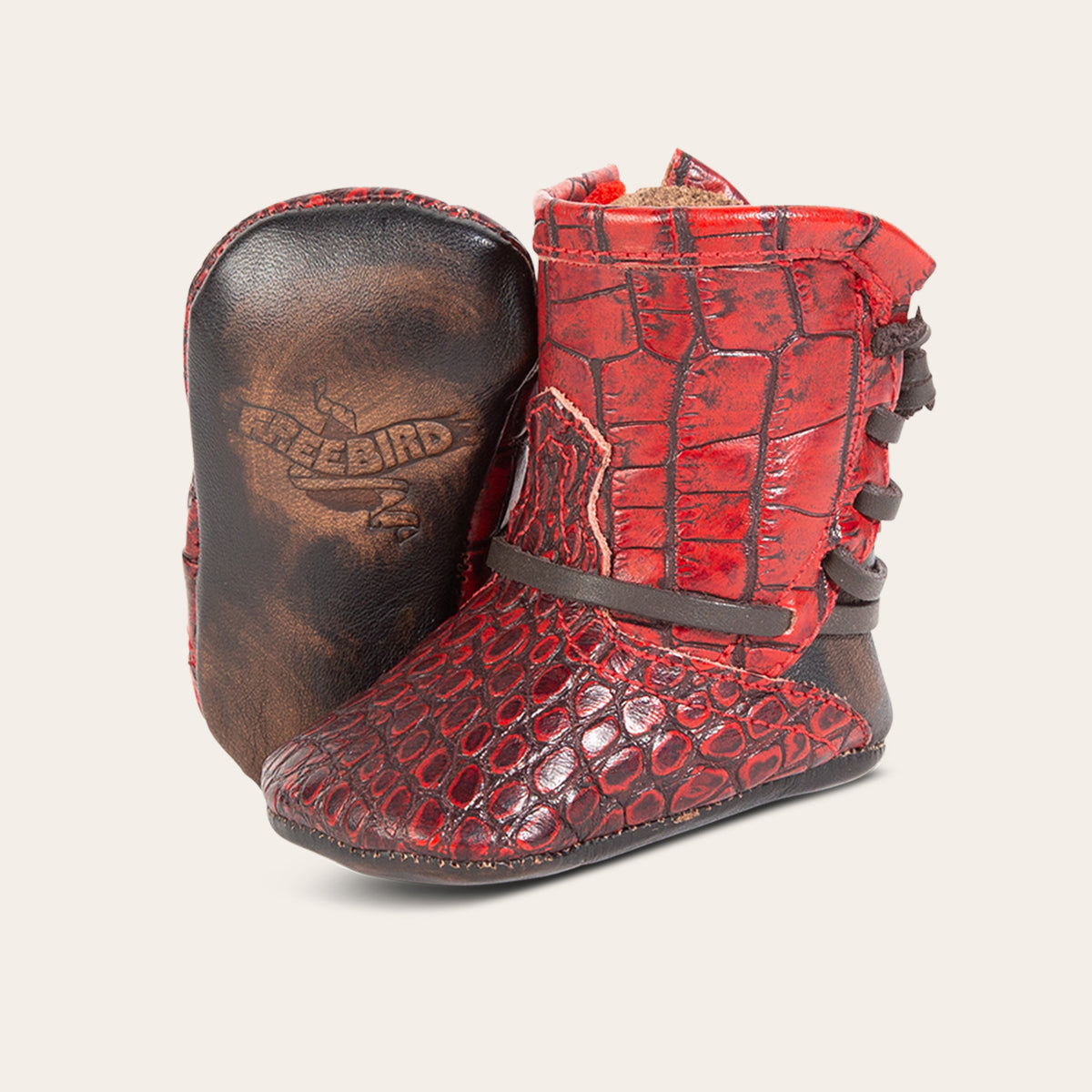 front view showing contrasting leather lace detailing and soft leather imprinted sole on FREEBIRD infant baby coal red croco leather bootie 