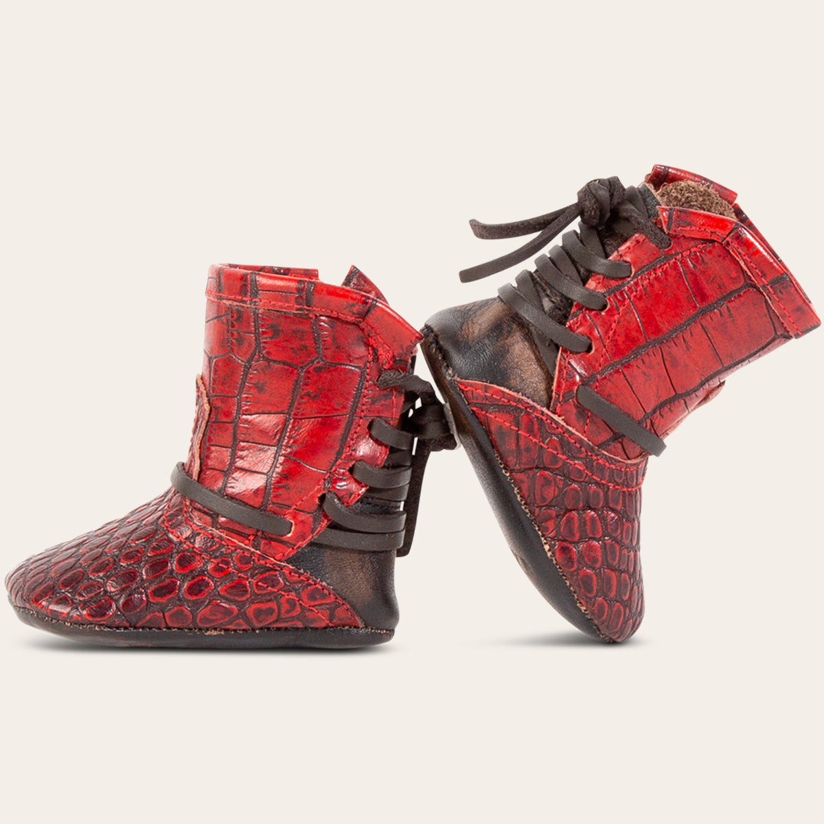 side view showing contrasting back lace detailing on FREEBIRD infant baby coal red croco leather bootie 
