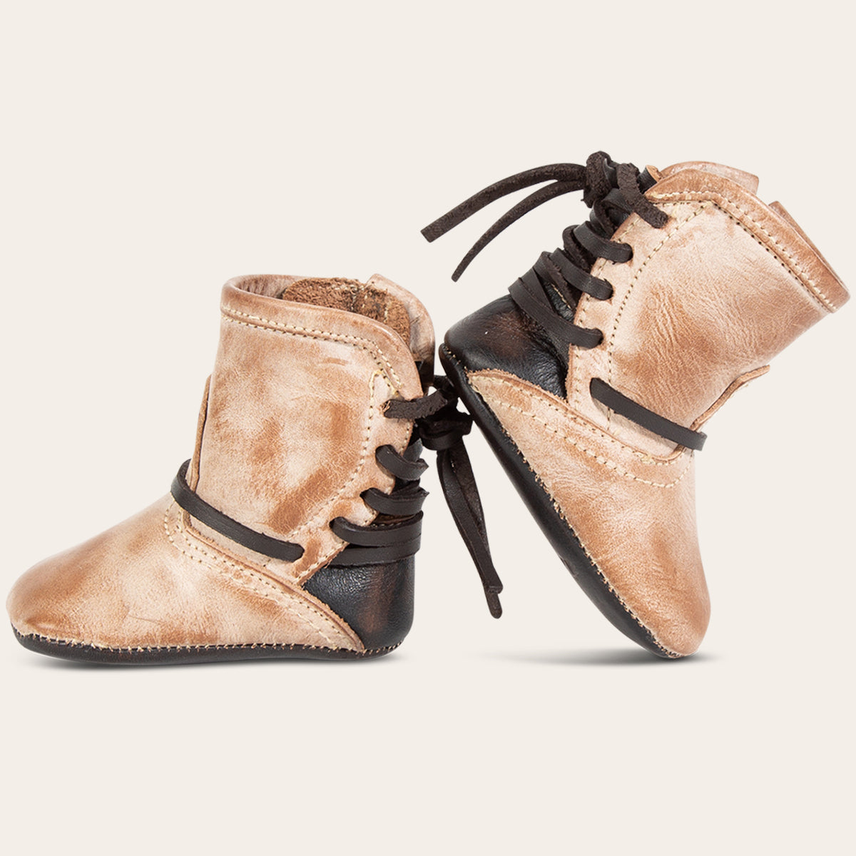 side view showing contrasting back lace detailing on FREEBIRD infant baby coal taupe leather bootie 