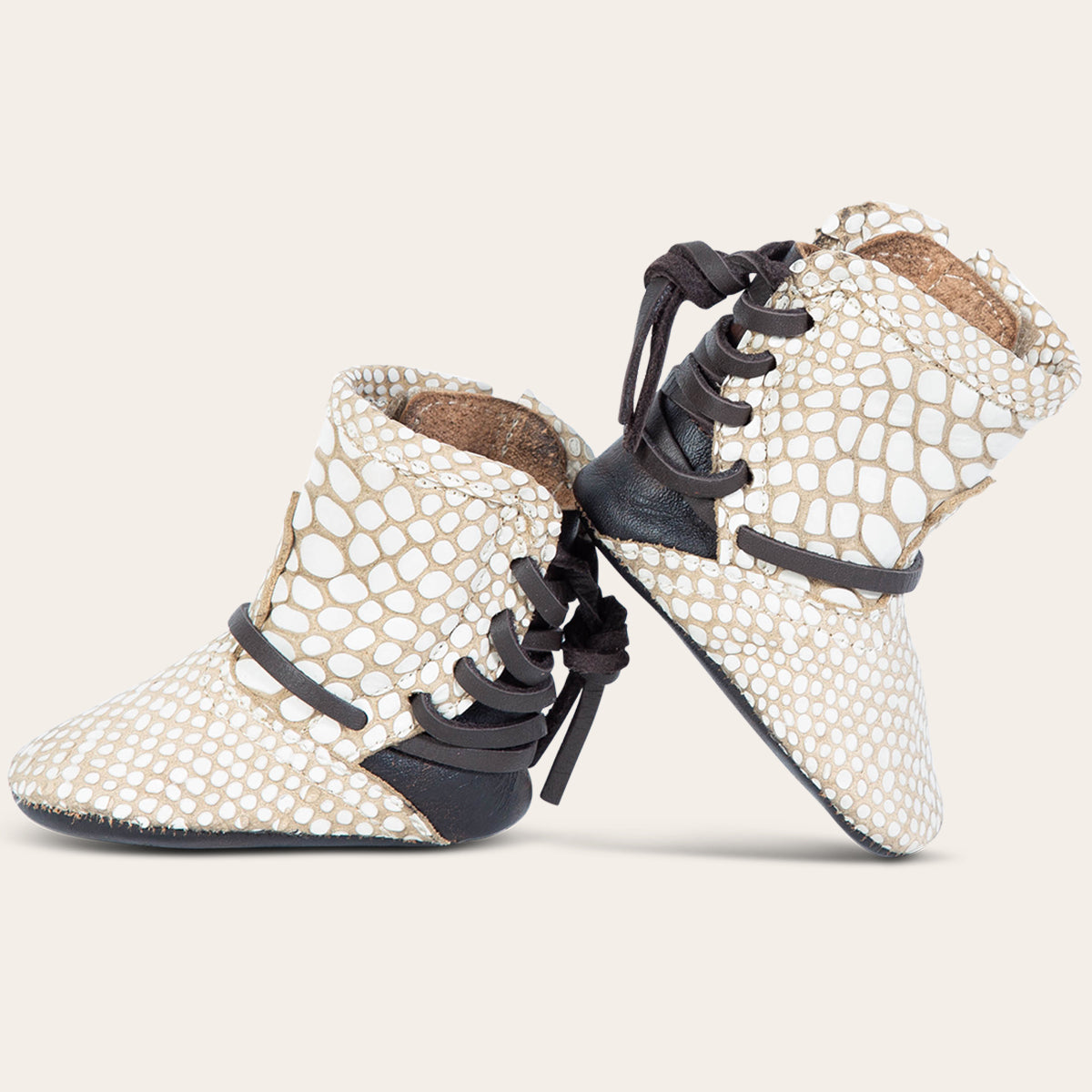 side view showing contrasting back lace detailing on FREEBIRD infant baby coal white snake leather bootie