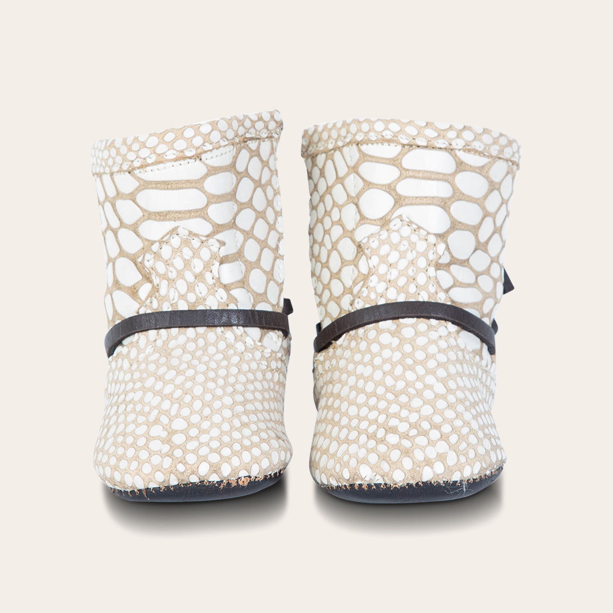 front view showing contrasting front lace detailing on FREEBIRD infant baby coal white snake leather bootie  