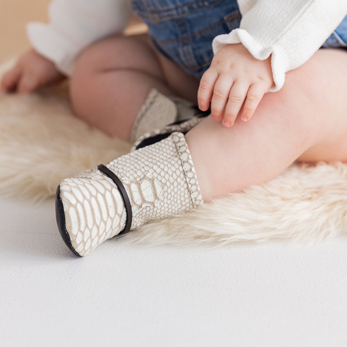 FREEBIRD infant baby coal white snake back lace detailing leather bootie with inside velcro closure lifestyle image