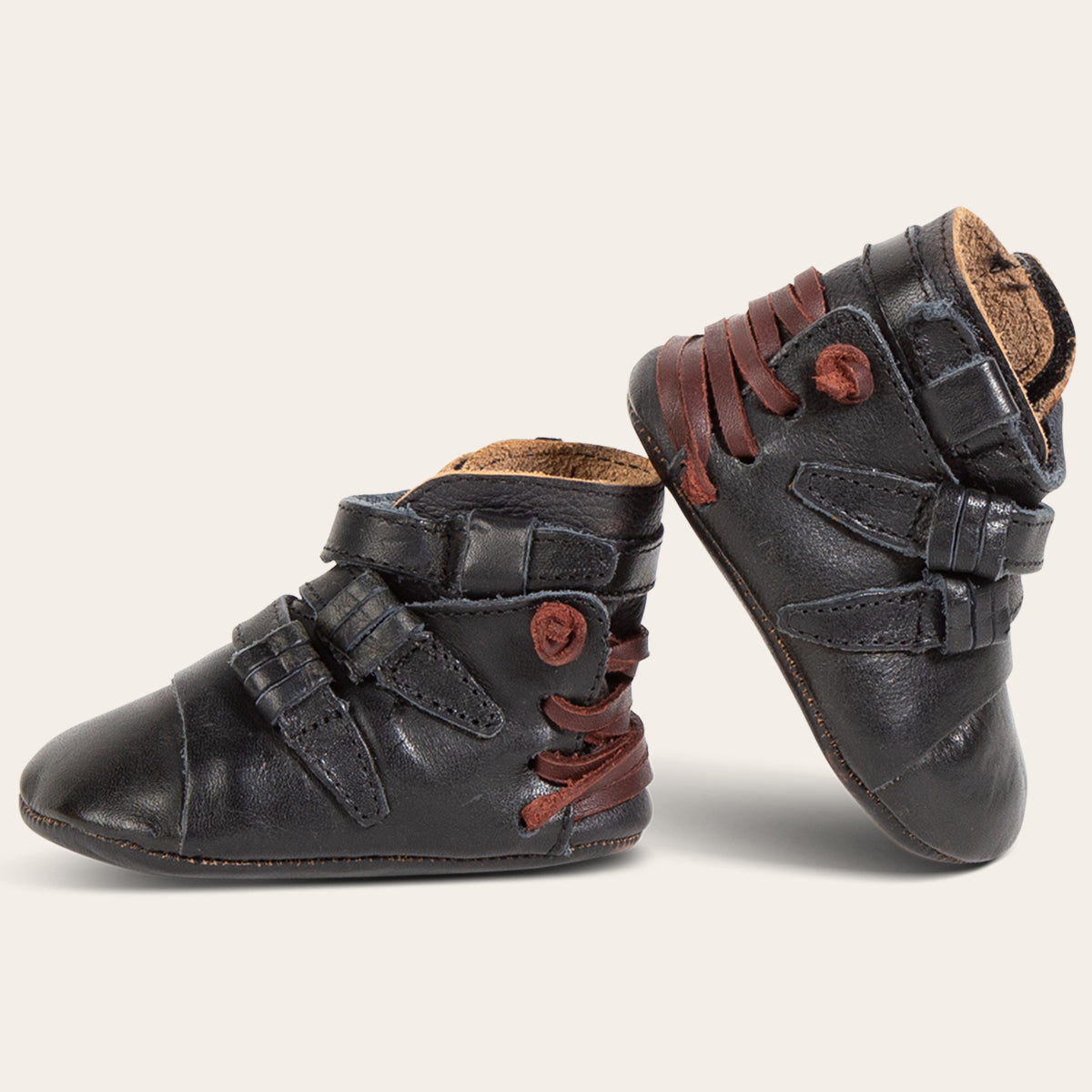 side view showing contrasting back lace and side strap detailing on FREEBIRD infant baby crue black leather bootie