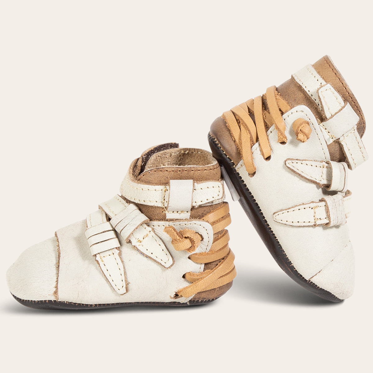 side view showing contrasting back lace and side strap detailing on FREEBIRD infant baby crue ice leather bootie