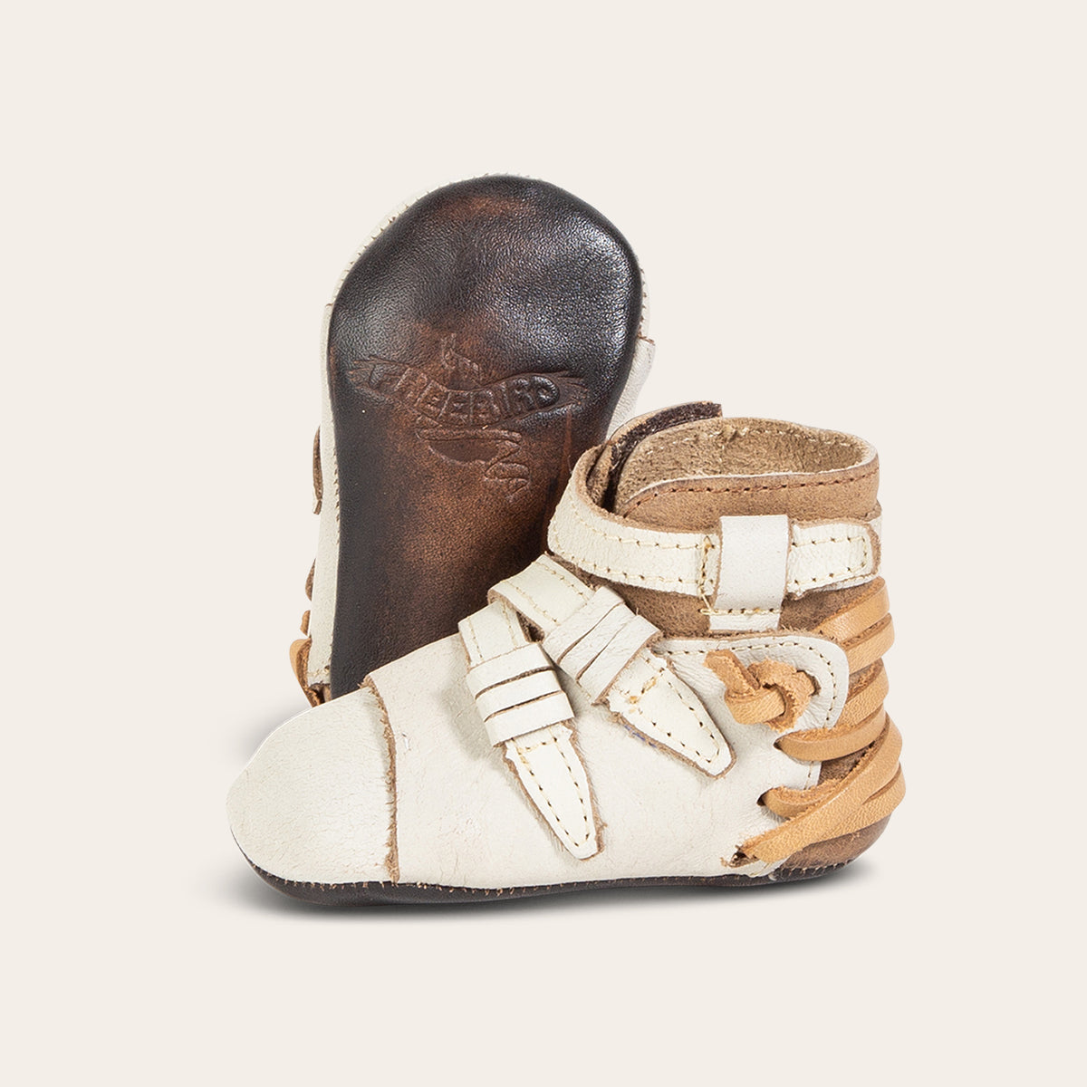 front view showing contrasting leather side strap detailing and soft leather imprinted sole on FREEBIRD infant baby crue ice leather bootie