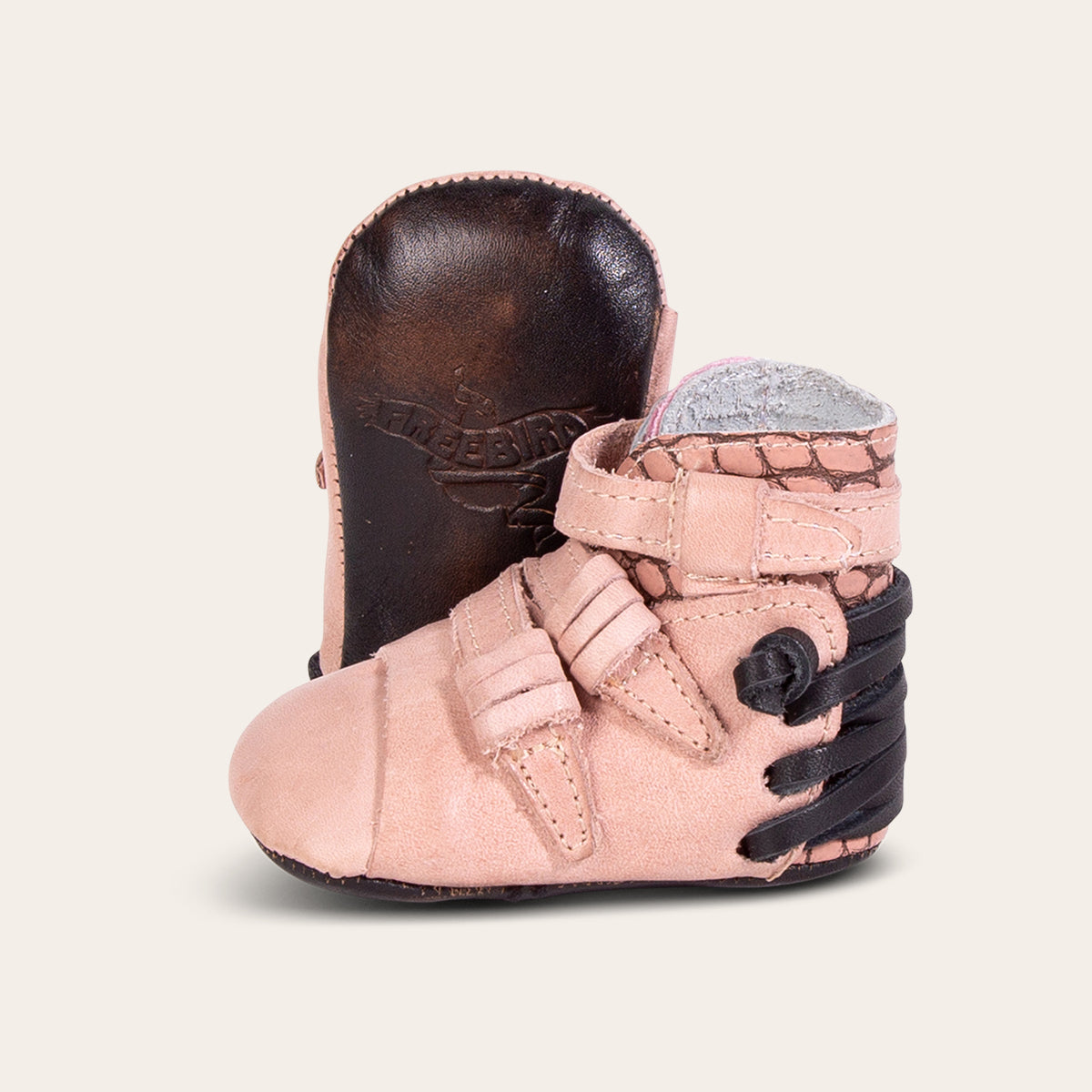 front view showing contrasting leather side strap detailing and soft leather imprinted sole on FREEBIRD infant baby crue pink multi leather bootie