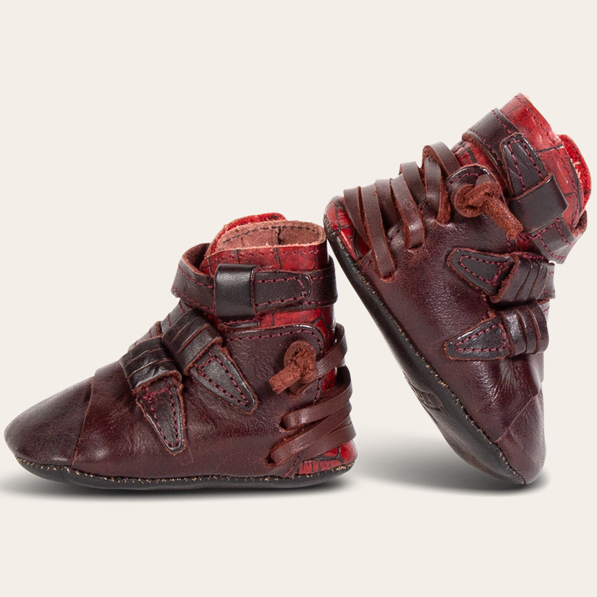 side view showing contrasting back lace and side strap detailing on FREEBIRD infant baby crue wine multi leather bootie