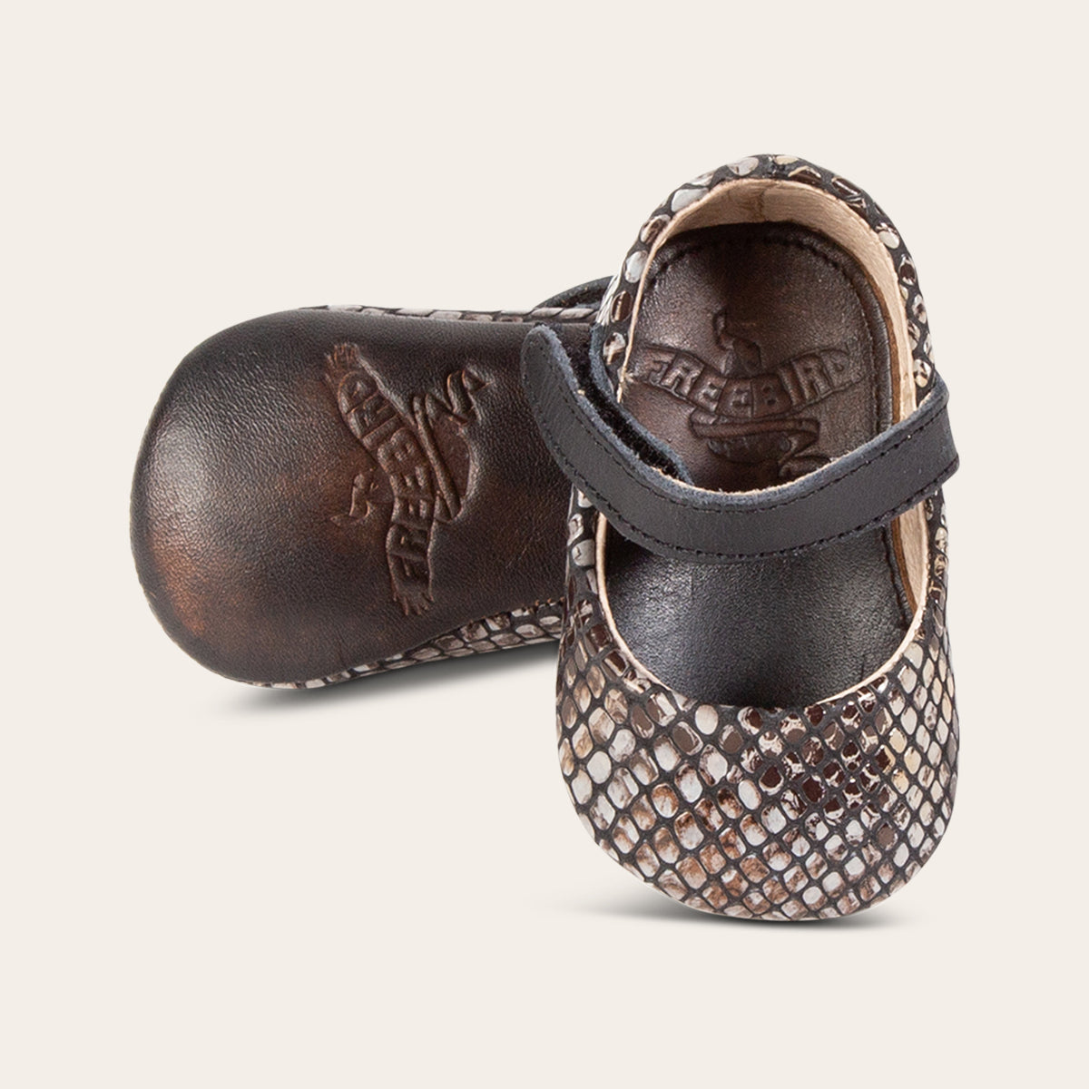 Side view showing leather strap detailing and soft leather imprinted sole on FREEBIRD infant baby Jane blue snake leather shoe