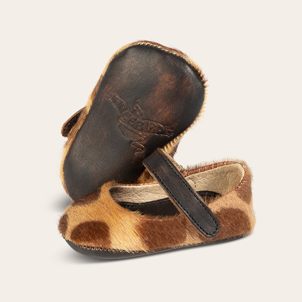 front view showing top leather strap and leather embossed sole on FREEBIRD infant baby Jane leopard leather shoe