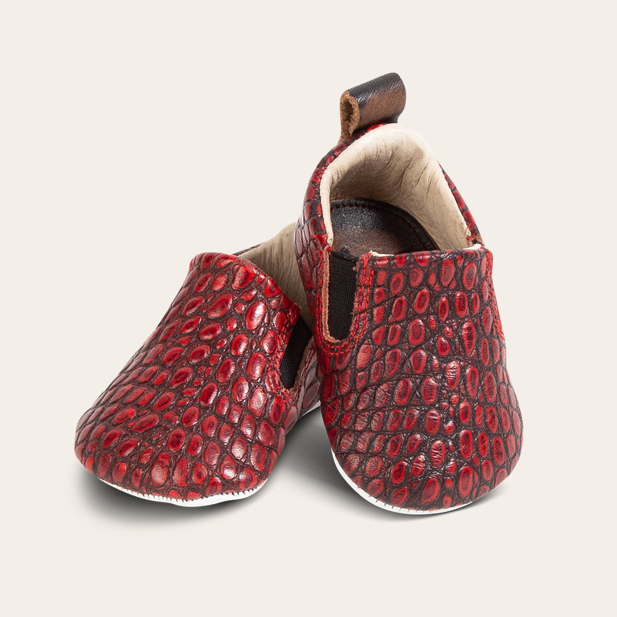 front view showing heel pull tab and side elastic panel on FREEBIRD infant baby kicks red croco leather shoe