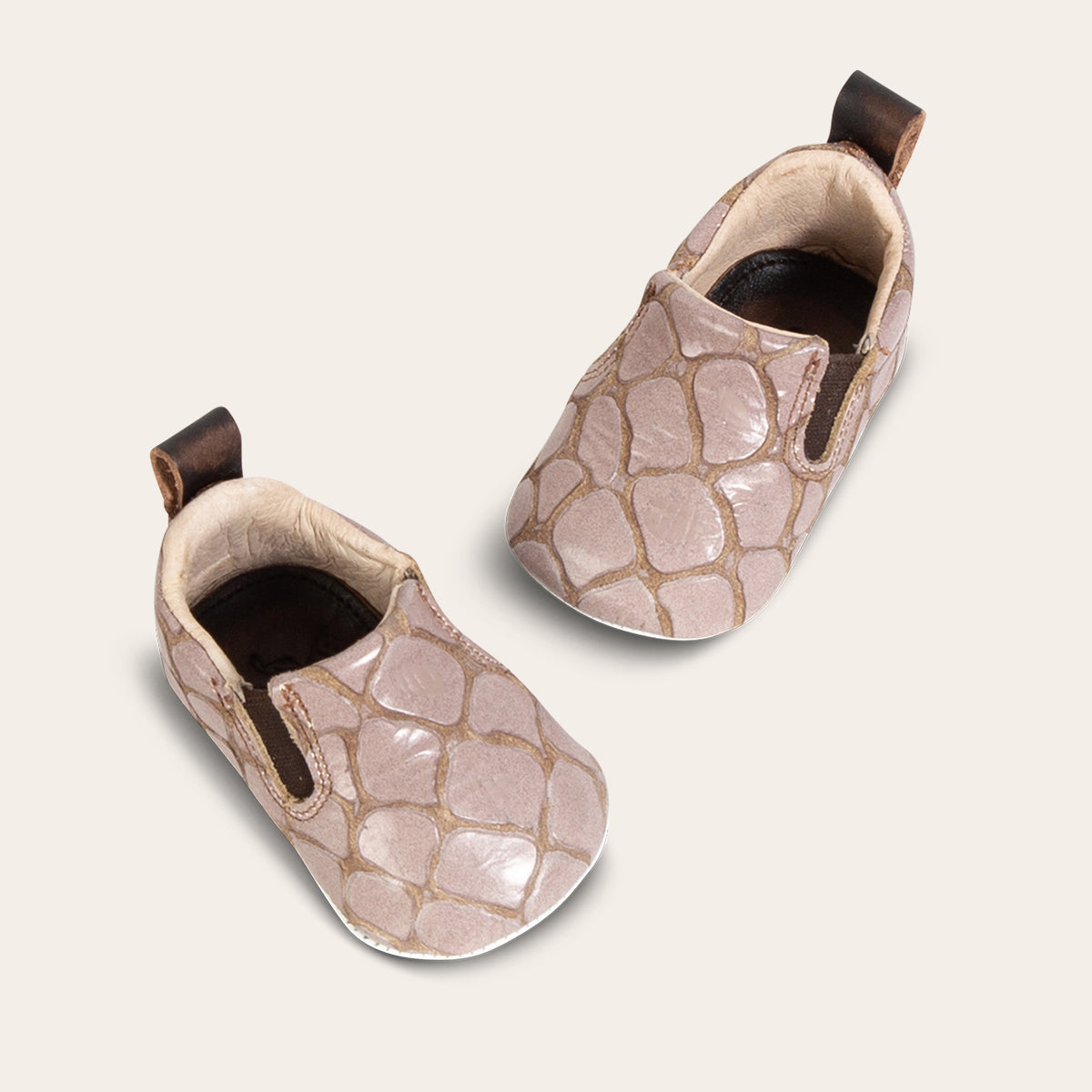top view showing heel pull tab and side elastic panel on FREEBIRD infant baby kicks stone croco leather shoe