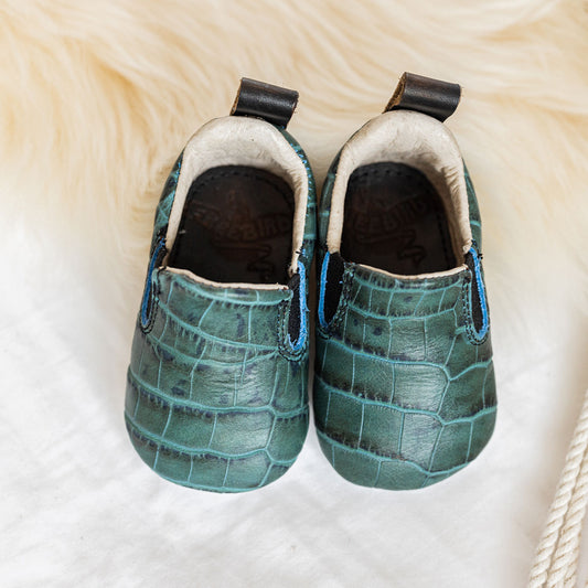 FREEBIRD infant baby kicks turquoise croco leather shoe with pull tab and side elastic panel lifestyle image