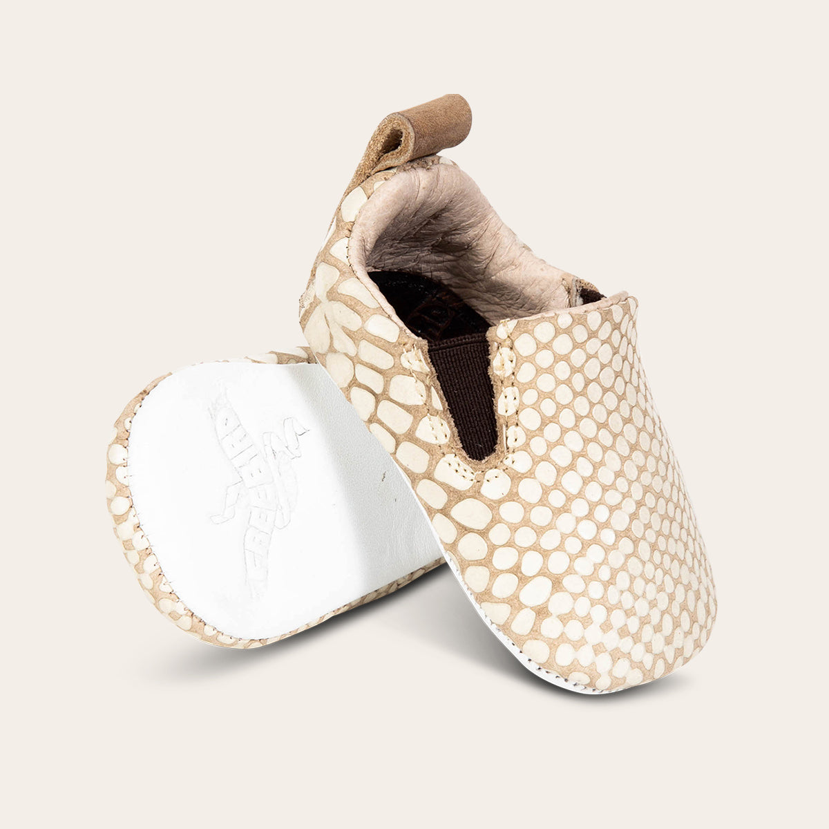 front view showing heel pull tab and side elastic panel and leather embossed sole on FREEBIRD infant baby kicks white snake leather shoe