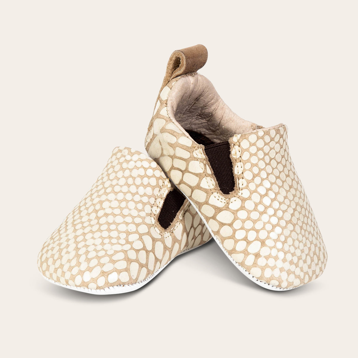 front view showing heel pull tab and side elastic panel on FREEBIRD infant baby kicks white snake leather shoe