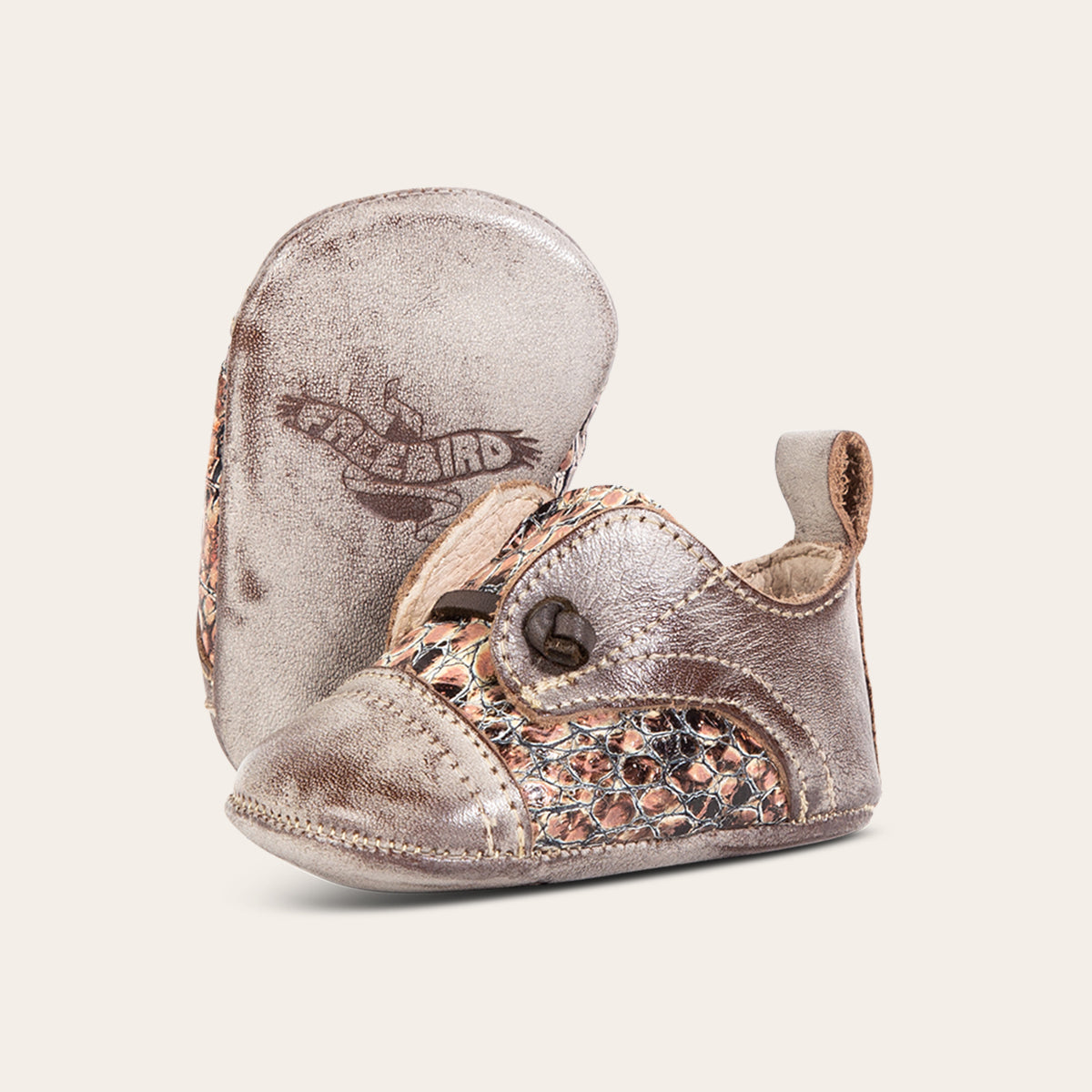front view showing pull tab contrasting decorative knotted leather lace and soft leather imprinted sole on FREEBIRD infant baby mabel pink multi leather shoe