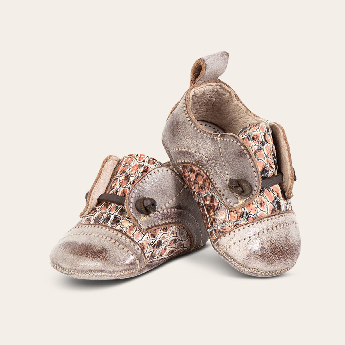 front view showing contrasting decorative knotted leather lace on FREEBIRD infant baby Mabel pink multi leather shoe
