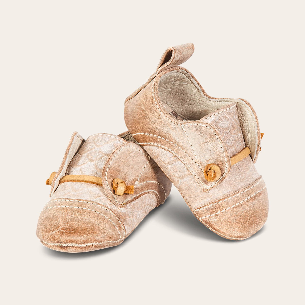 front view showing contrasting decorative knotted leather lace on FREEBIRD infant baby mabel taupe leather shoe