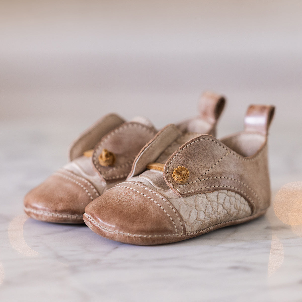 FREEBIRD infant baby Mabel taupe leather shoe with decorative knotted leather lace and hidden inside elastic panel lifestyle image