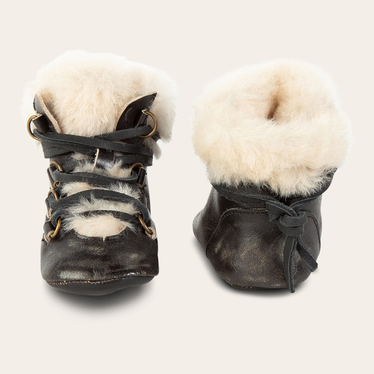 front and back view showing shearling lining and contrasting leather lace detailing on FREEBIRD infant baby Norway cognac leather bootie