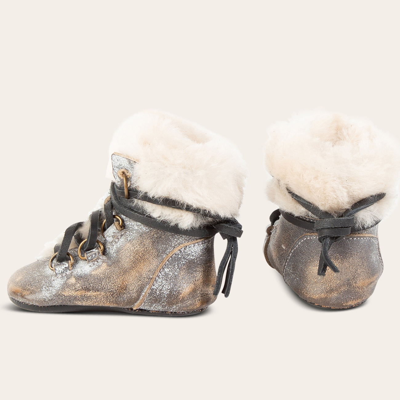 side and back view showing shearling lining and contrasting leather lace detailing on FREEBIRD infant baby Norway ice leather bootie