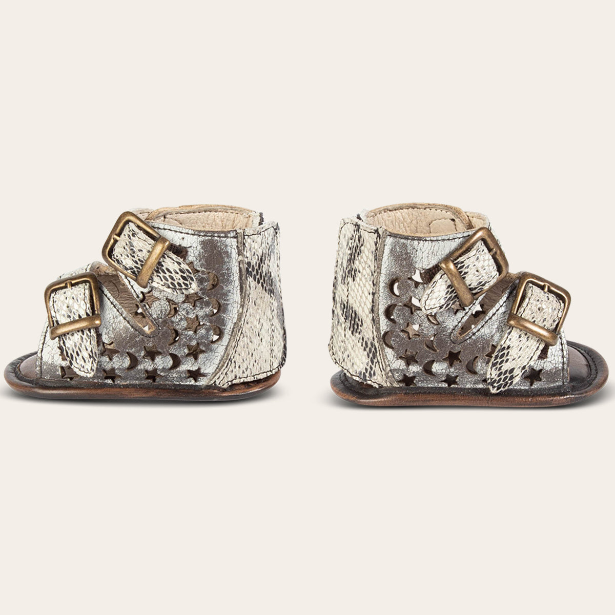 side view showing laser-cut leather, embossed fashion straps, back velcro panel on FREEBIRD infant baby teresa ice leather sandal
